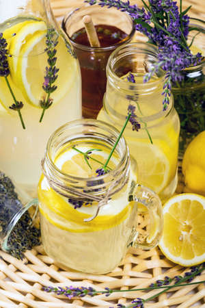 Lemonade with Lemons and Lavender. Cold Infused Detox Water with Lemon and Lavender. Provence Style. Selective focus.の写真素材