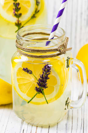 Lemonade with Lemons and Lavender. Cold Infused Detox Water with Lemon and Lavender. Provence Style. Selective focus.の写真素材