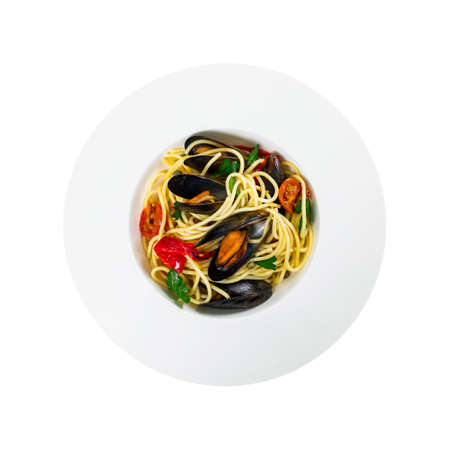 Delicious Seafood Pasta Spaghetti with Mussels and Tomatoes Isolated on White Background. Italian Cuisine. Selective focus.の写真素材
