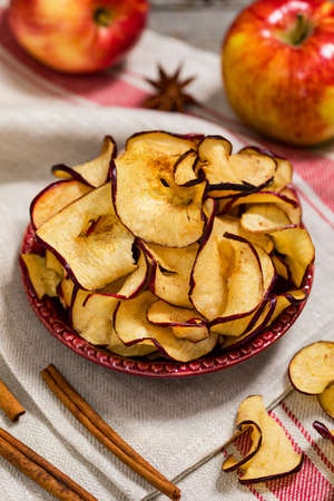 Baked Red Apple Chips with Cinnamon. Selective focus.の写真素材