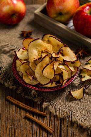 Baked Red Apple Chips with Cinnamon. Selective focus.の写真素材