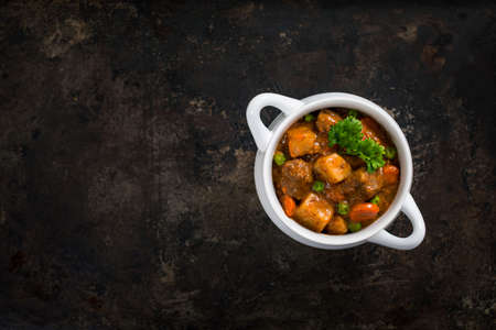 Beef Stew with Potatoes and Carrots on Rustic Metal Background.の写真素材