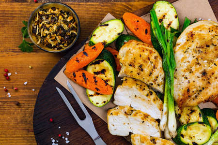 Grilled Chicken Breasts with Grilled Vegetables Zucchini and Carrot Background. Selective focus.の写真素材