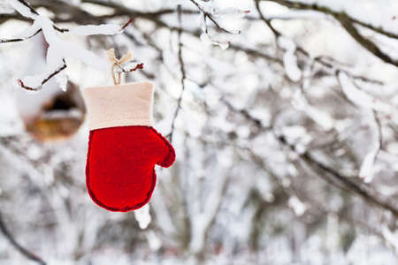 Christmas Background. Red and White Felt Mitten on a Natural Background. Selective focus.の写真素材
