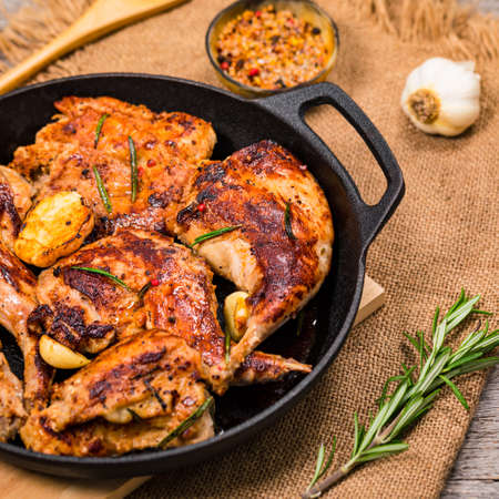 Braised Fried Rabbit with Rosemary, Garlic and Olive Oil on Wooden Background. Selective focus.の写真素材