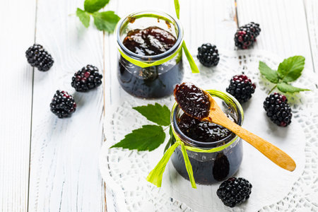 Blackberry Jam Preserves on Old Wooden Background. Selective focus.