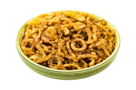 Crispy Fried Onion Strings with Garlic and Pepper Isolated on White Background. Selective focus.の写真素材