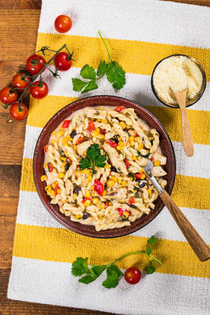 Cheesy Grilled Chicken Alfredo Pasta Florentine with Black Beans and Corn. Selective focus.の写真素材