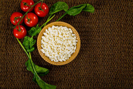 Feta Crumbled Cheese with Spinach and Tomatoes Background. Selective focus.の写真素材