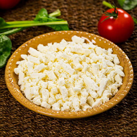 Feta Crumbled Cheese with Spinach and Tomatoes Background. Selective focus.の写真素材