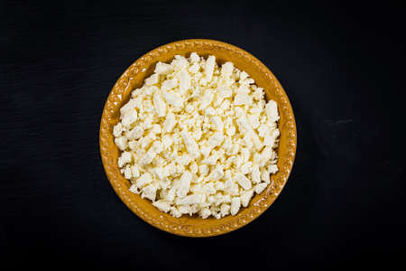 Feta Crumbled Cheese on Black Background with Copy Space. Selective focus.の写真素材