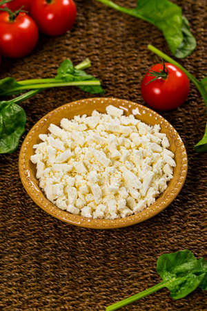 Feta Crumbled Cheese with Spinach and Tomatoes Background. Selective focus.の写真素材