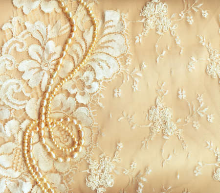 
Wedding background with cream silky decoration accessories, lace and pearlsの写真素材