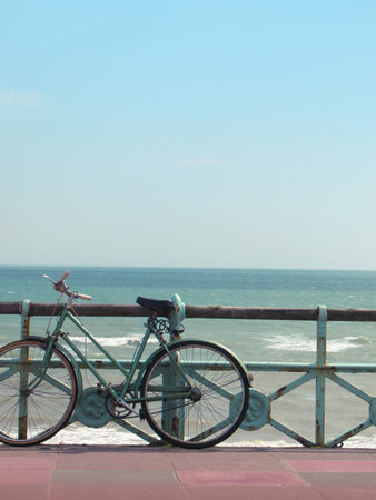 A vintage beach bike against turquoise sea.