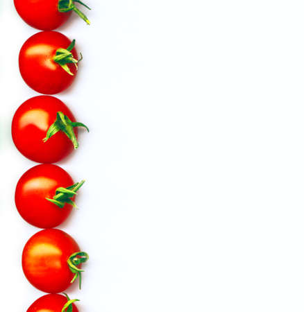 A line of red organic cherry tomatoesの写真素材