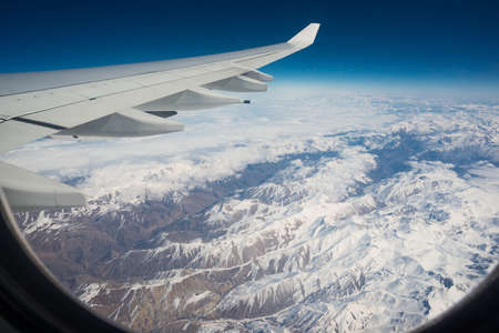 view of airplane wing over snow mountains,  landscapeの写真素材