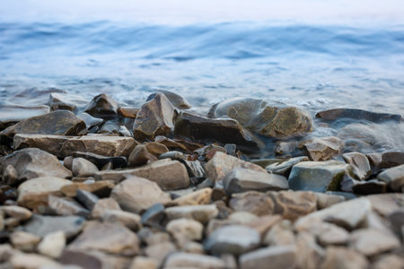 the stony coast with a waveの写真素材