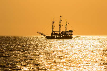 silhouette of the ancient ship at sunsetの写真素材