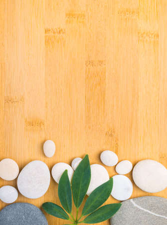 pebbles and green leaf on the bamboo  backgroundの写真素材