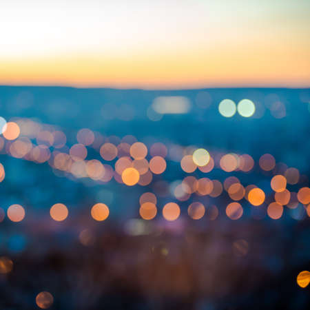 city blurring lights abstract circular bokeh on blue background with horizon, closeup  の写真素材