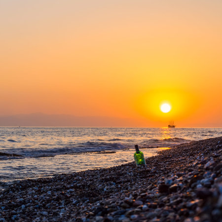 romantic landscape of the sea, ship silhouette and bottleの写真素材