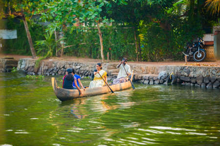ALLEPPEY, INDIA - FEBRUARY 23: An unidentified man and a women in traditional boat are sailing from the coast. India, Kerala, Alleppey (Alappuzha). February 23, 2013のeditorial素材