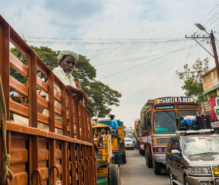 THANJAVOUR, INDIA - FEBRUARY 13: An unidentified Indian man stands in the truck at the traffic congestion  rural road. India, Tamil Nadu, near Thanjavour. February 13, 2013のeditorial素材