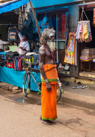 THANJAVOUR, INDIA - FEBRUARY 14: An unidentified Holy Sadhu man with traditional painted face at street. India, Tamil Nadu, Thanjavour(Darasuram). February 14, 2013のeditorial素材