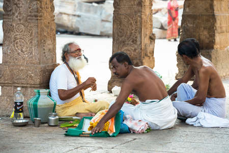 MADURAI, INDIA - FEBRUARY 16: Hindu Brahmin with religious attributes providing ceremony and are blessing pilgrims at holy place Sri Meenakshi Amman Temple. India, Tamil Nadu, Madurai. February 16, 2013のeditorial素材