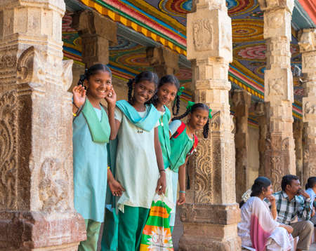 MADURAI, INDIA - FEBRUARY 16: An unidentified smiling schoolgirl in uniform are standing in Sri Meenakshi Amman Temple. India, Tamil Nadu, Madurai. February 16, 2013のeditorial素材