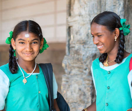 MADURAI, INDIA - FEBRUARY 16: An unidentified smiling girl in school uniform are standing in Sri Meenakshi Amman Temple. India, Tamil Nadu, Madurai. February 16, 2013のeditorial素材