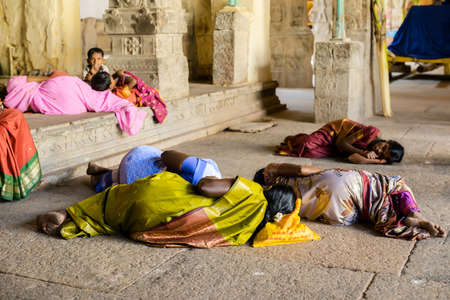 MADURAI, INDIA - FEBRUARY 16: An unidentified pilgrims and child are resting in the ancient Brihadisvara Temple of Sri Meenakshi Amman Temple. India, Tamil Nadu, Madurai. February 16, 2013のeditorial素材