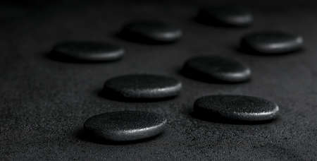 spa concept of zen stones on black background with dew, panoramaの写真素材