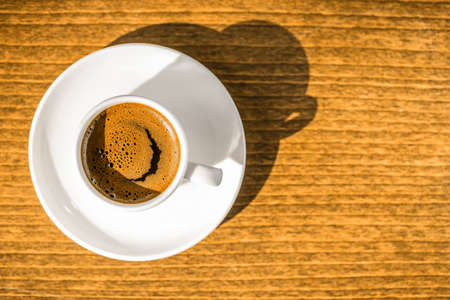 top down morning creativity concept, smiled cup coffee with sunbeams, closeupの写真素材