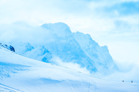 beautiful winter landscape of Dombaj with clouds and descent from the mountain