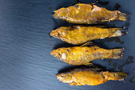 top view of fried tench fish served on slate background, close upの写真素材