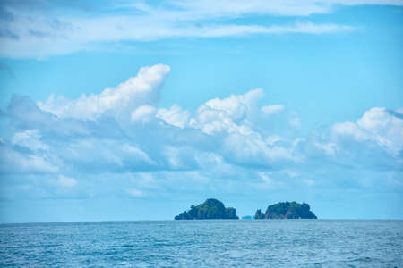 beautiful tropical blue ocean and clouds on sky with two islands, travel background, Thailandの写真素材