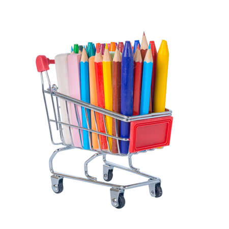 education concept with chrome shopping cart, pens, crayons, colorful chalks is isolated on white background, close upの写真素材