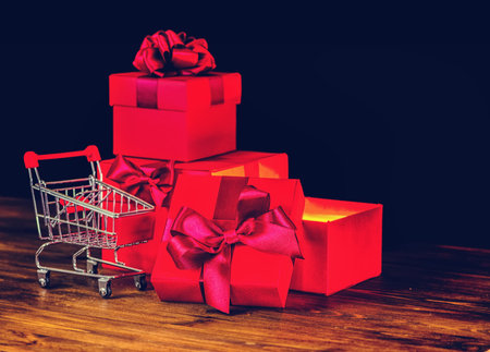 sale concert, presents, holiday greeting card with festive opened boxes with bow and shopping cart...