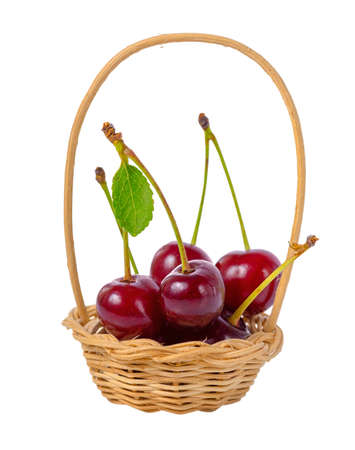 red ripe cherries with leaf in basket isolated on white background, close upの写真素材