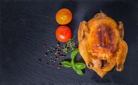 Thanksgiving concept with roasted Turkey, tomato, dry peppers, rosemary and green basil leaves, flat design,
close upの写真素材