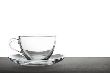 empty transparent tea cup isolated on wooden over white background, mock upの写真素材