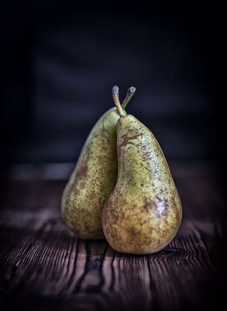 Couple pears on old rustic wooden table backgroundの写真素材