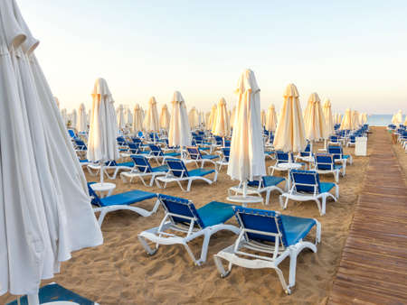 sandy beach to sea with wooden footpath, sun beds, umbrellas, Turkey, Side resortの写真素材