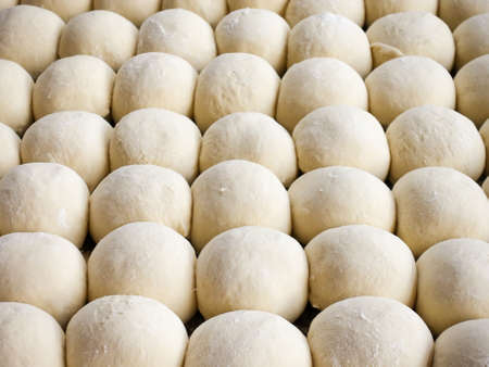 fresh raw dough balls background, trendy seamless pattern from bakery, concept of healthy eatingの写真素材