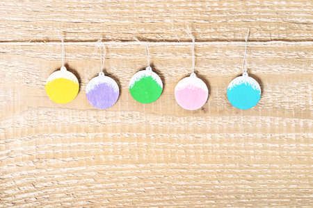 Christmas simple background with decorated painted balls on wooden surface, close upの写真素材