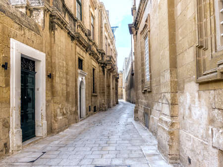 beautiful view of narrow medieval street with doors, windows in old town Mdina, Malta, toned effectの写真素材