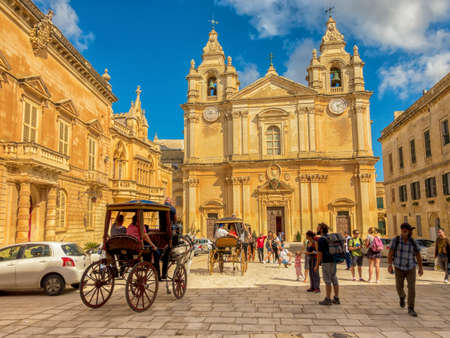 Mdina, Malta, October 7, 2017: picturesque horse carriage and tourists on catholic St. Peter & Paul Cathedral  のeditorial素材