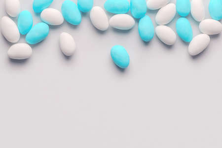 Top view of blue, pink and white sugared almond candies for wedding like background with copy spaceの写真素材