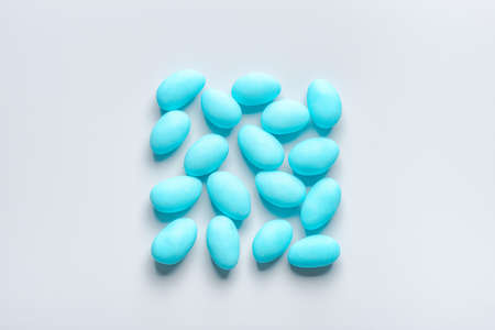 Flat lay of blue sugared almond candies square shape on background from aboveの写真素材